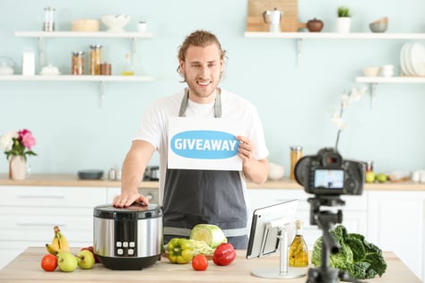 Content creator hosting a cooking giveaway session on live social media to engage and reward viewers.