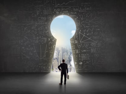 Man with briefcase walking through a keyhole-shaped entrance.