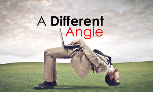 Man in suit, bent over backwards, with a laptop on his lap, and the words A Different Angle above him.