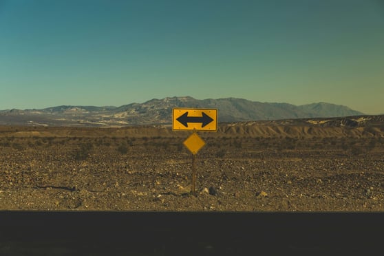 Yellow two directions sign in a desert landscape