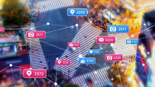 Social media stats over city crosswalk, highlighting digital engagement and the benefits of LinkedIn Ads for targeting.