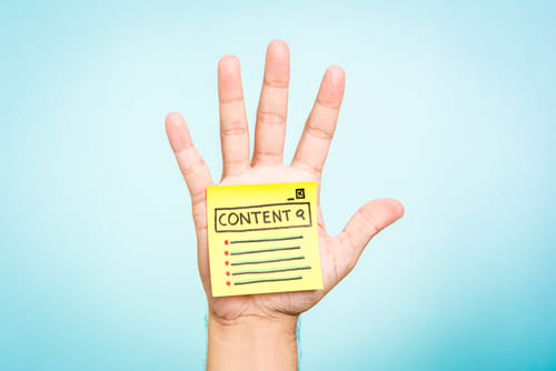 Hand showing a note about search "content" word.